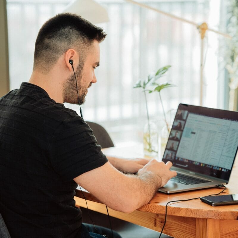 Man working at laptop computer with Jim2 screen and reporting ERP