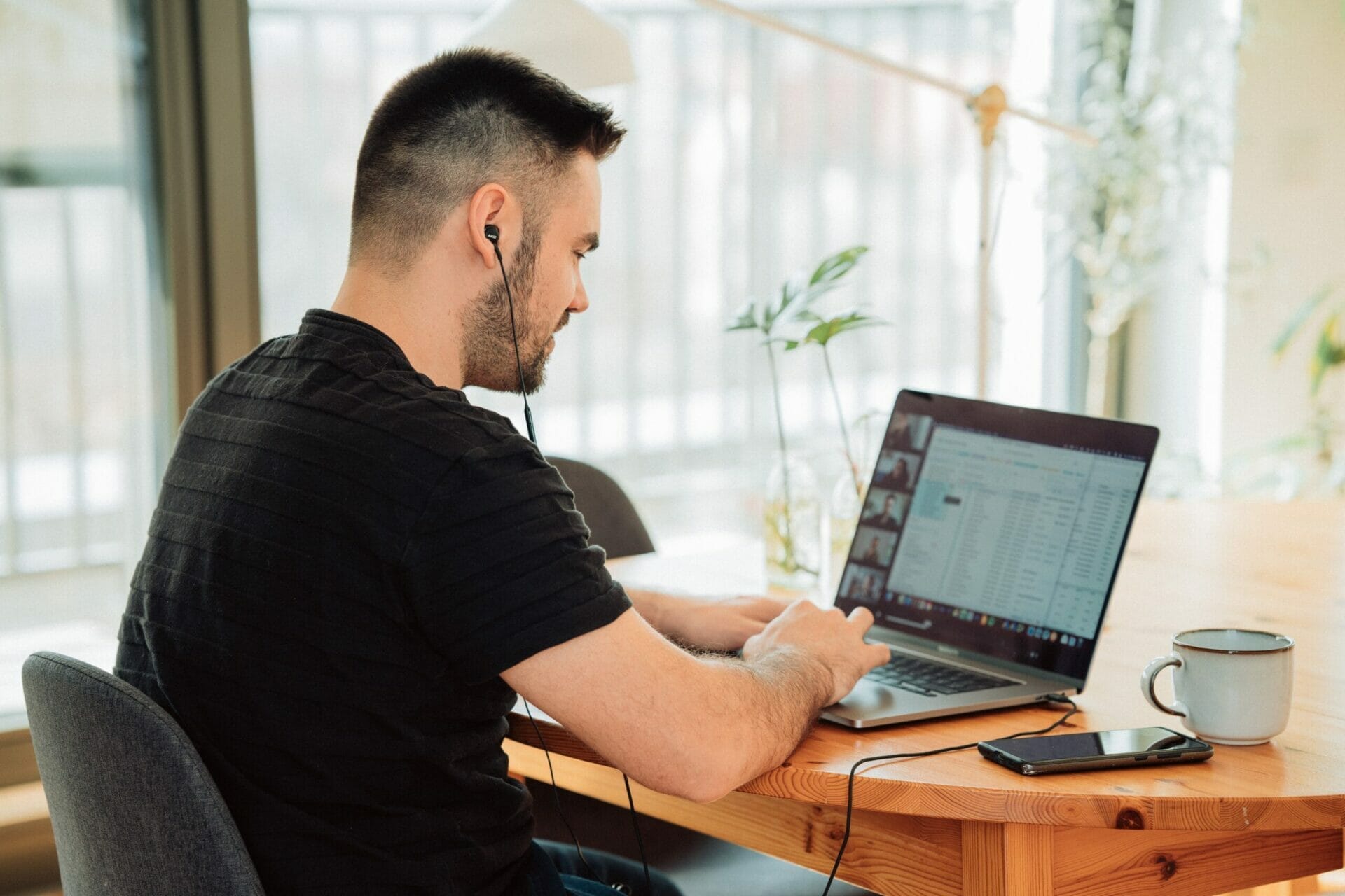 Man working at laptop computer with Jim2 screen and reporting ERP