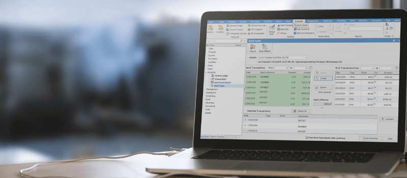 laptop screen with Jim2 ERP Saas in green